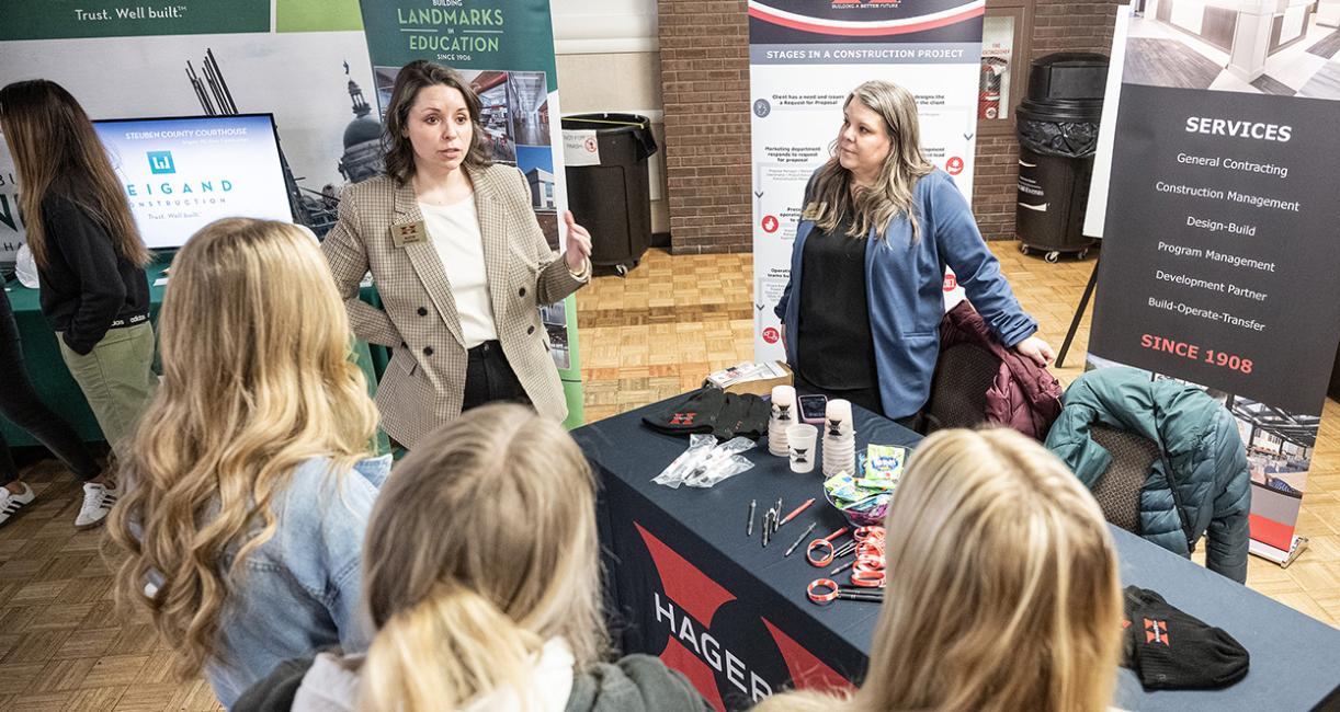 Attendees at a conference are speaking to each other