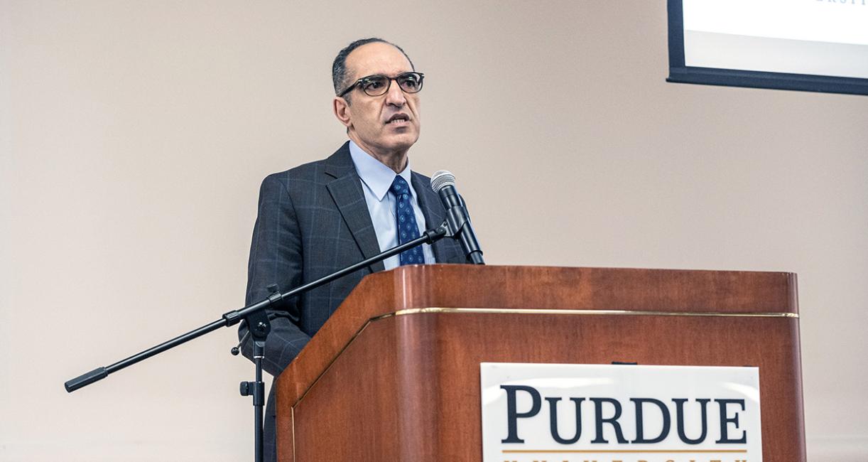 A college dean is speaking to an audience