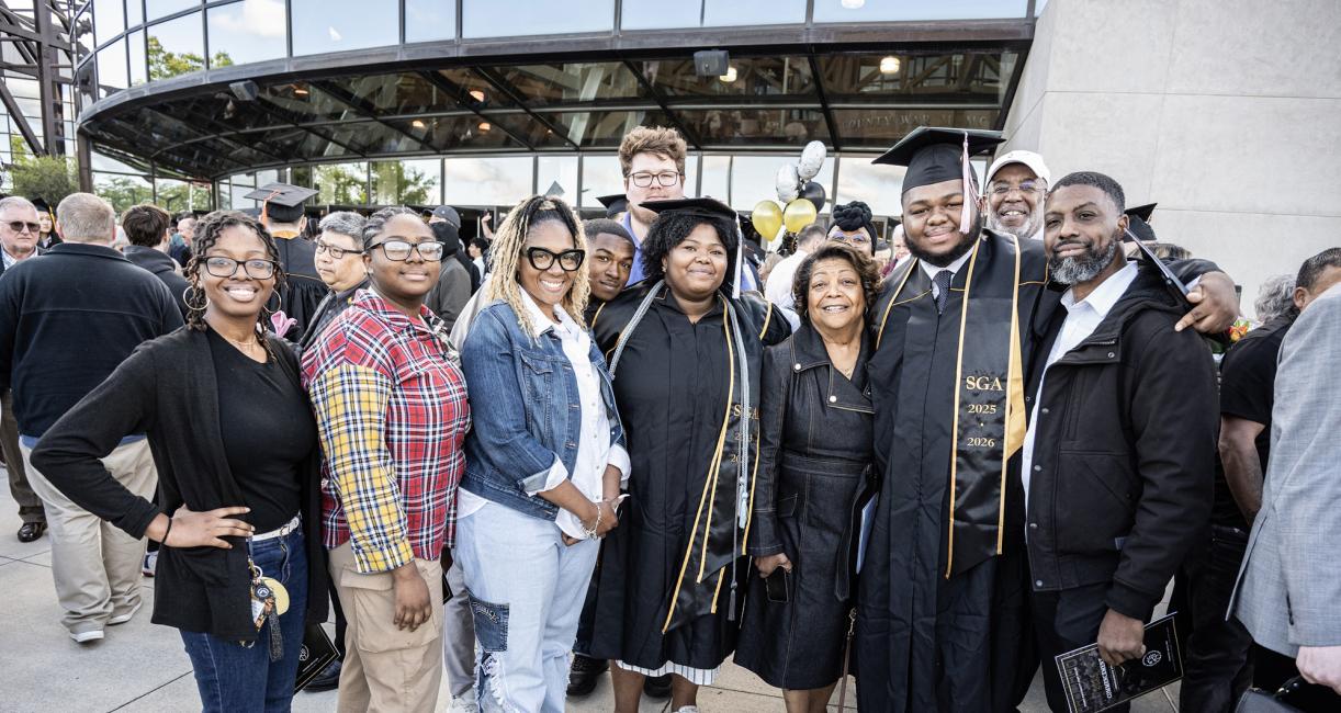 A family poses outside the 2026 commencement ceremony