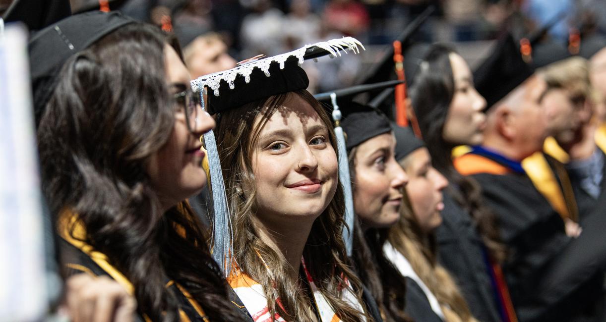 A student in a decorated cap attends the 2026 commencement ceremony