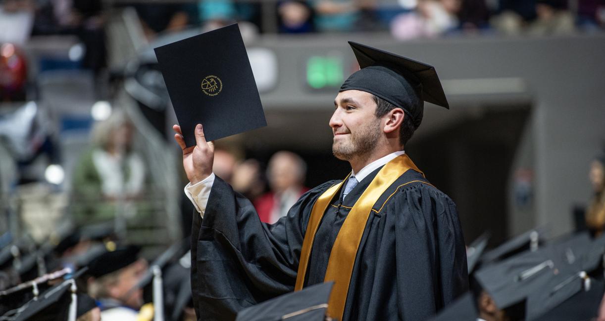 A student recieves a degree at the 2026 commencement ceremony