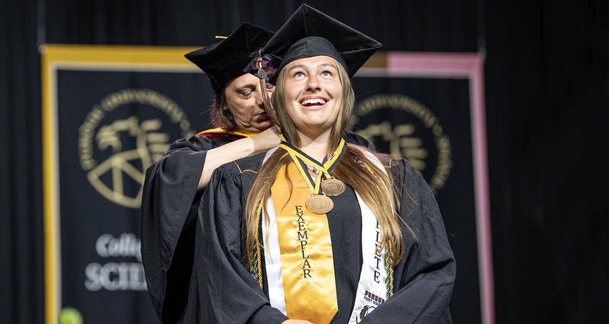 A female student recieves an honor at the 2026 commencement ceremony