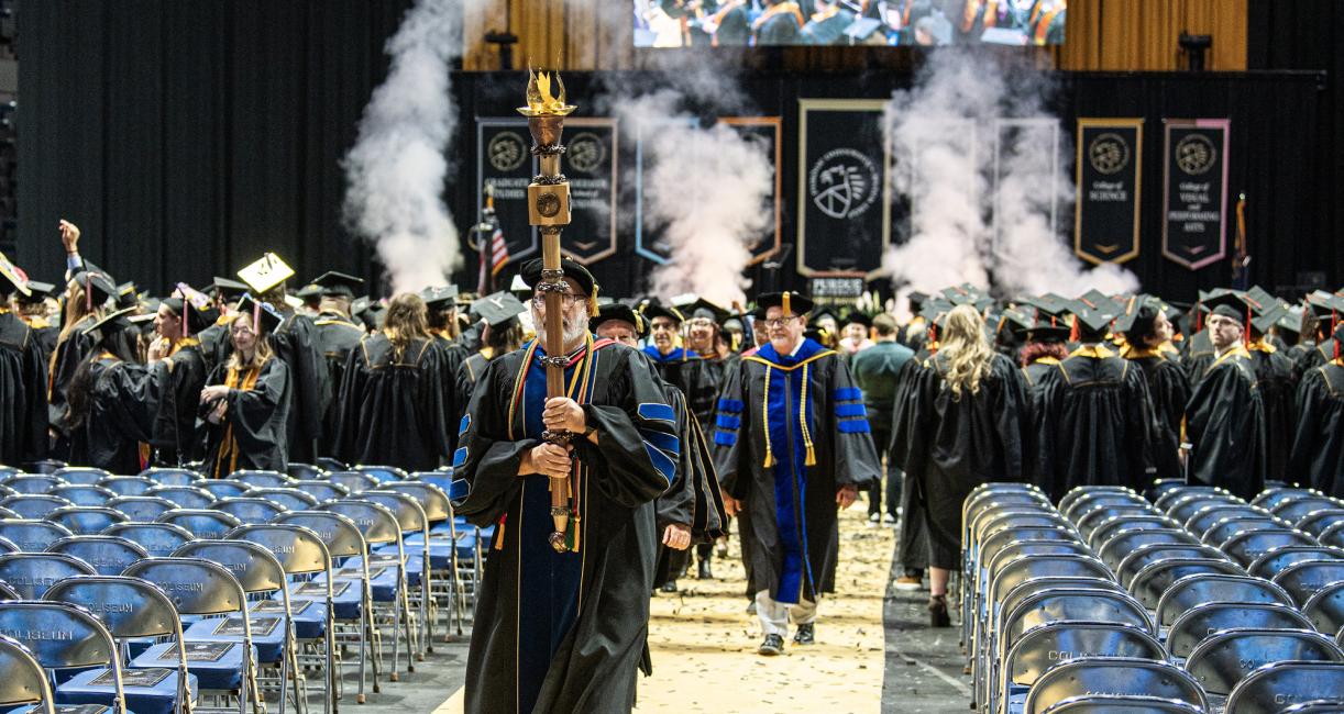 The ceremonial mace leaves the 2026 commencement ceremony